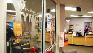 Interior view of the Flagler County YMCA front desk and lobby with community program signs