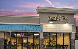 Front entrance of The Art House creative studio in St. Augustine, Florida, with open sign and workshop displays