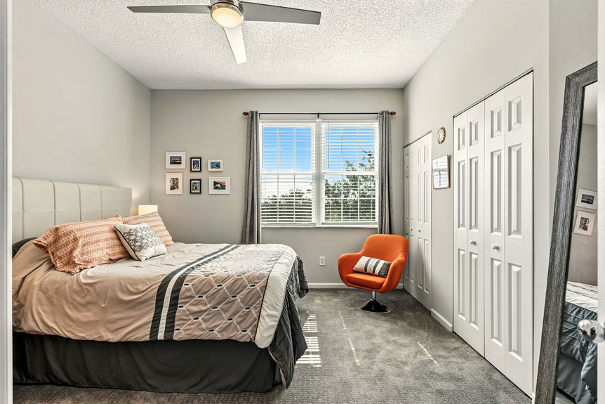 Master bedroom with large window and double closets, perfect for serene living