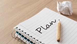 Notebook with the word “Plan” and pencil, representing preparation for a St. Augustine, Florida new construction home design center appointment.