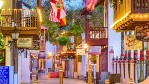 Colorful view of Historic Downtown St. Augustine with colonial architecture, shops, and festive lights.