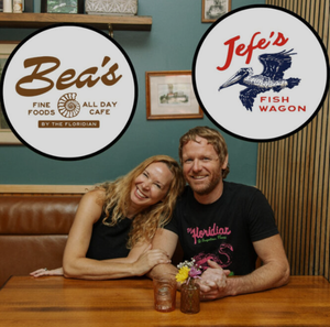 Owners of Bea’s Fine Foods and Jefe’s Fish Wagon sitting at a table, smiling inside their St. Augustine restaurant