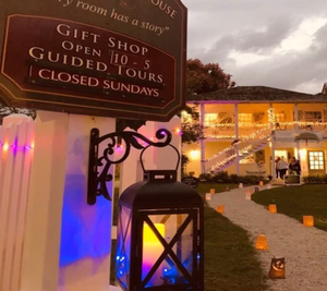 Lantern-lit path leading to the Ximenez-Fatio House Museum in St. Augustine during an evening local art market