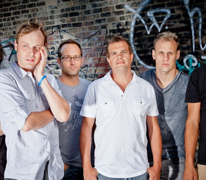 Band photo of Umphrey’s McGee promoting their Cruising Altitude 2025 Tour with a live performance at the St. Augustine Amphitheatre.