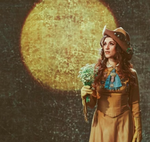Promotional image of singer Sierra Ferrell in Western-inspired attire holding flowers with a glowing moon backdrop, announcing her live performance at The Amp in St Augustine, Florida.