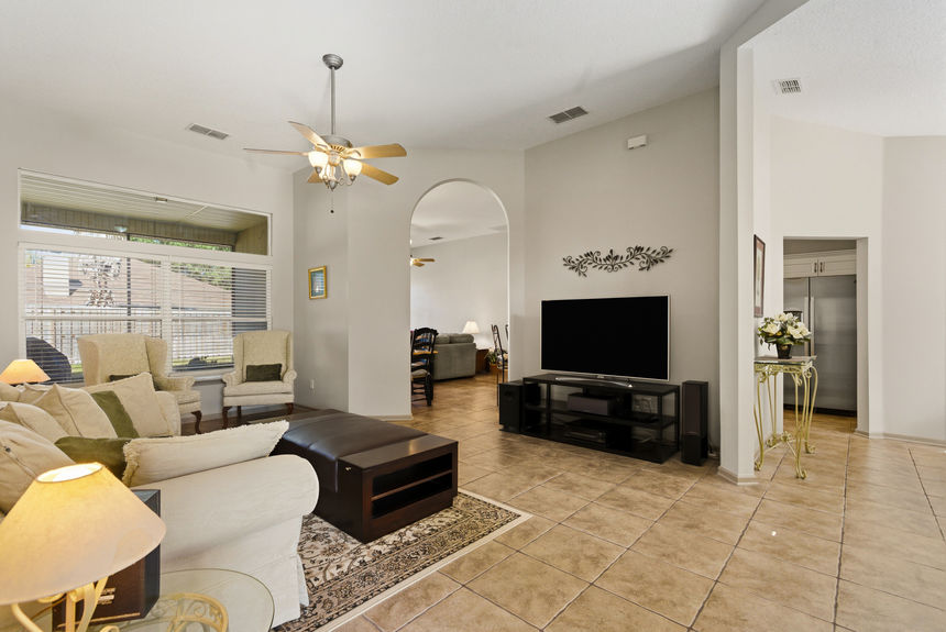 Open living room with tile floors and natural light in a St. Johns Florida home
