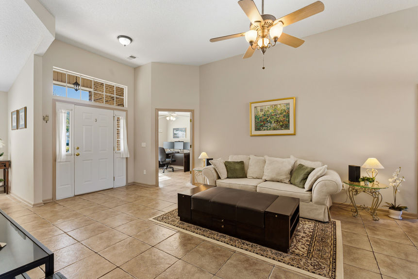 Open living room with tile floors and natural light in a St. Johns Florida home