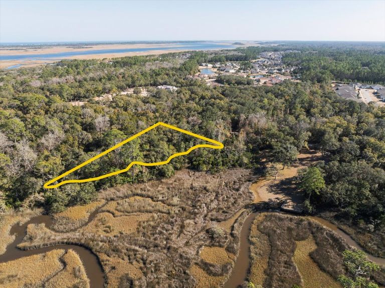 Aerial shot with property lines outlined, angled to show how the lot is positioned to maximize views of the distant Intracoastal Waterway.