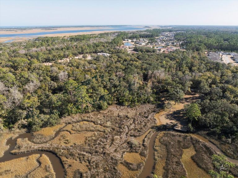 Wide aerial shot with a lot outline, showing the property's secluded location relative to the nearby Intracoastal Waterway and Nocatee amenities.