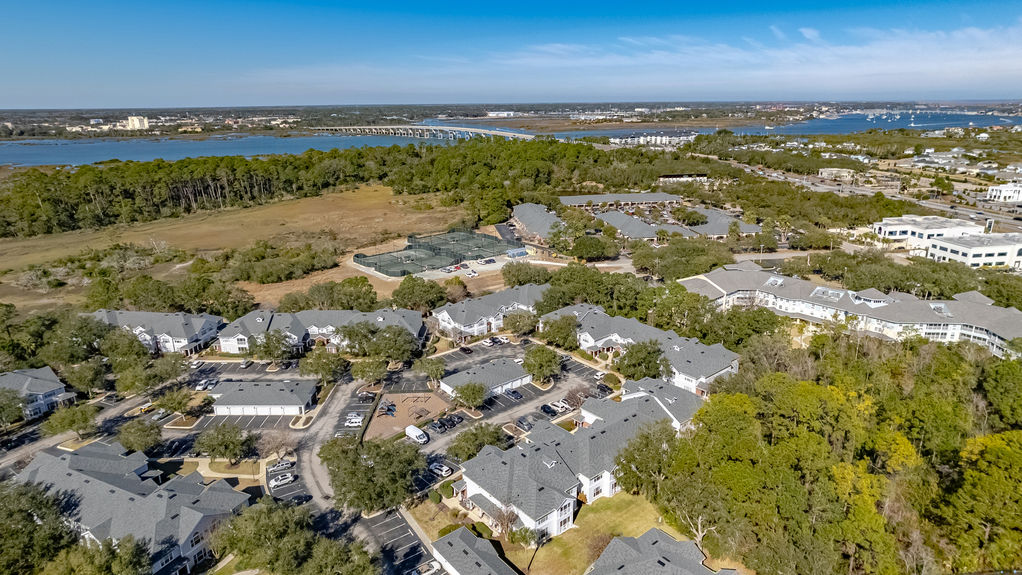 Drone photo of the Harbour Vista Circle condo complex surrounding a central lake with fountain in St. Augustine, FL.