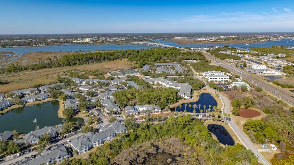 Drone photo of the Harbour Vista Circle condo complex surrounding a central lake with fountain in St. Augustine, FL.