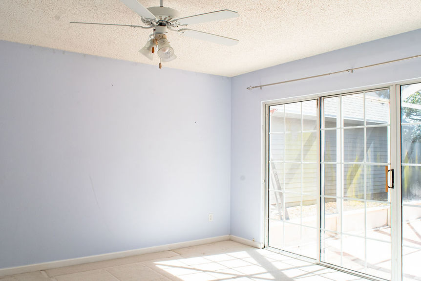 A bedroom at 364 Village Dr with sliding glass doors opening to a private screened patio in the Villages of Vilano gated community