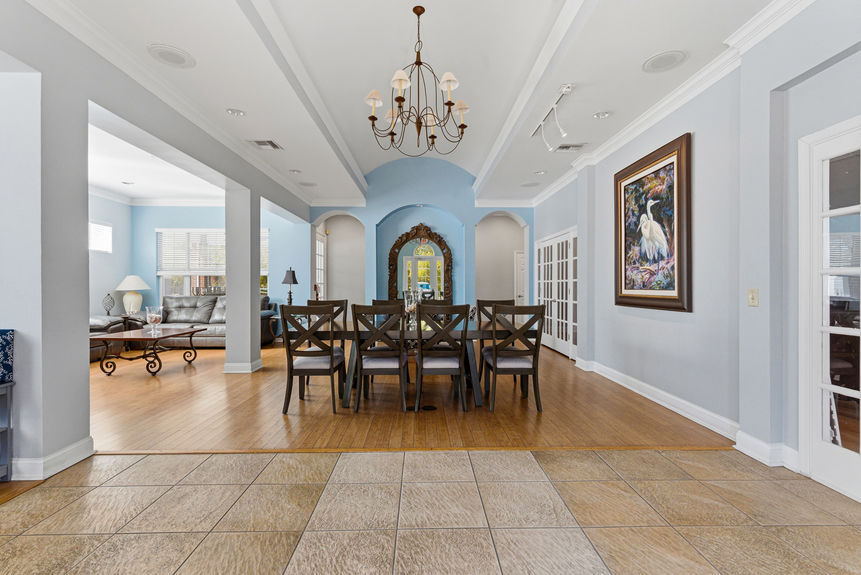 Large dining area in the St. Augustine Harbour Vista Cir clubhouse with tray ceilings and modern fixtures.