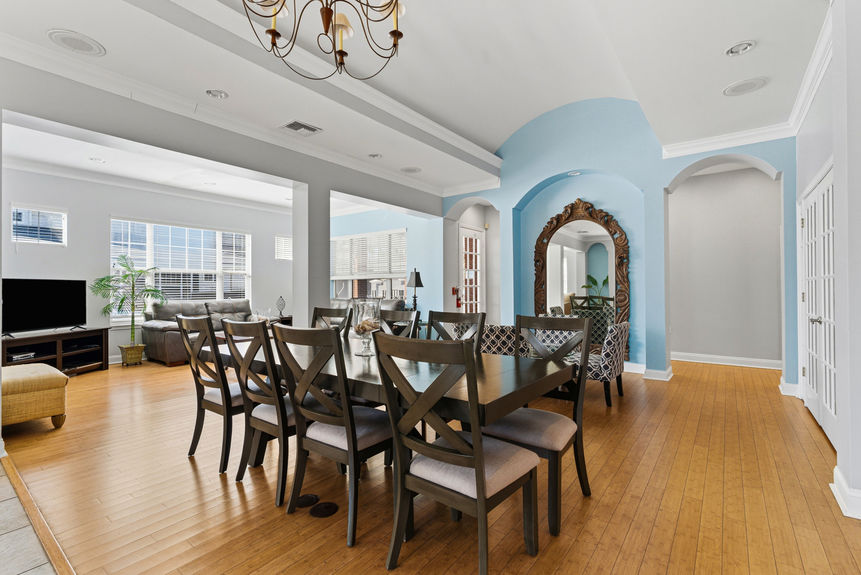 Large dining area in the St. Augustine Harbour Vista Cir clubhouse with tray ceilings and modern fixtures.