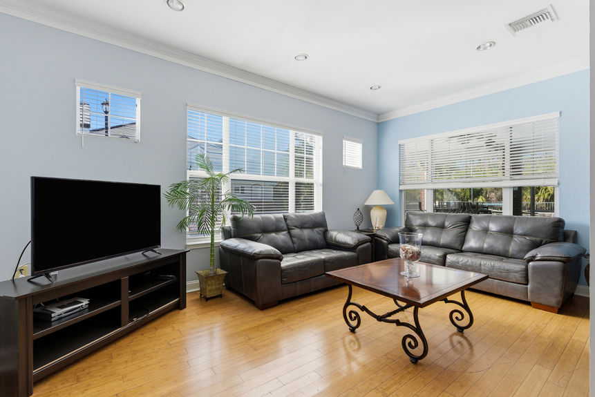 Social lounge in the Harbour Vista Cir center featuring leather sofas and coastal blue accents in St. Augustine, FL.