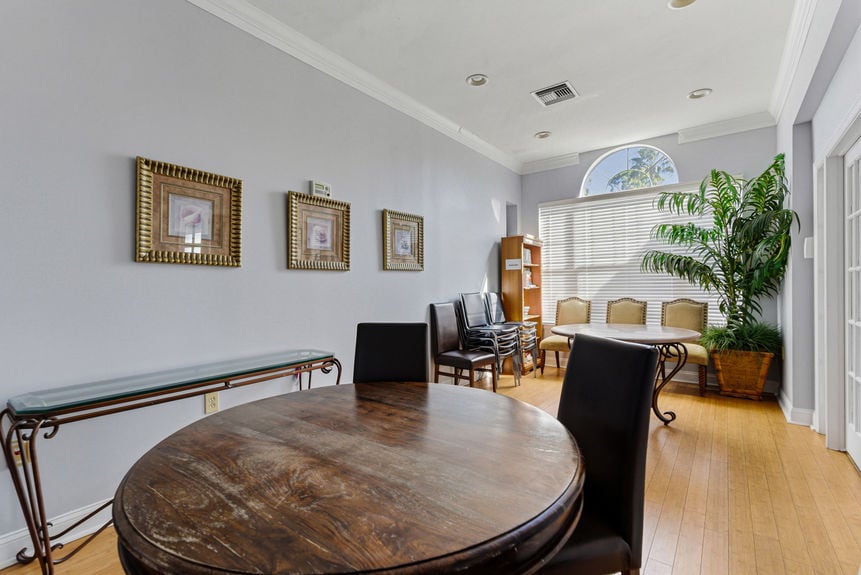 Large dining area in the St. Augustine Harbour Vista Cir clubhouse with tray ceilings and modern fixtures.