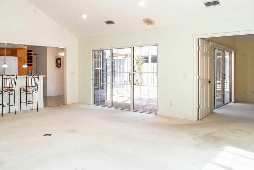 Interior view of 364 Village Dr showing the transition from the living area to a private outdoor patio through sliding glass doors.