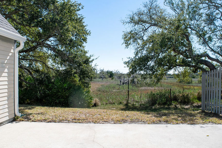 A tranquil view of the natural marsh and nature preserve from the rear patio of 364 Village Dr, located in the gated Villages of Vilano community in St. Augustine, Florida.