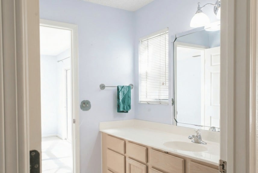 Primary bathroom vanity with dual mirrors and integrated lighting in the 3-bedroom home at 364 Village Dr.