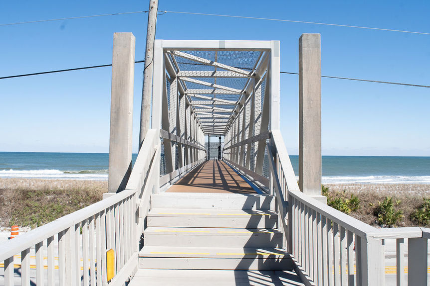 A secure, elevated pedestrian bridge providing direct private beach access for residents of the Villages of Vilano gated community in St. Augustine, Florida.