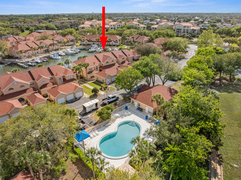 High-altitude aerial photo with a red arrow pointing to 37 Captains Walk, showing its proximity to the Intracoastal and the Atlantic Ocean.