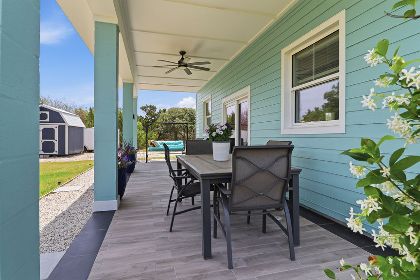 Close-up of the covered outdoor dining area and patio at 5900 Costanero Road, featuring a ceiling fan and tiled flooring in St. Augustine.