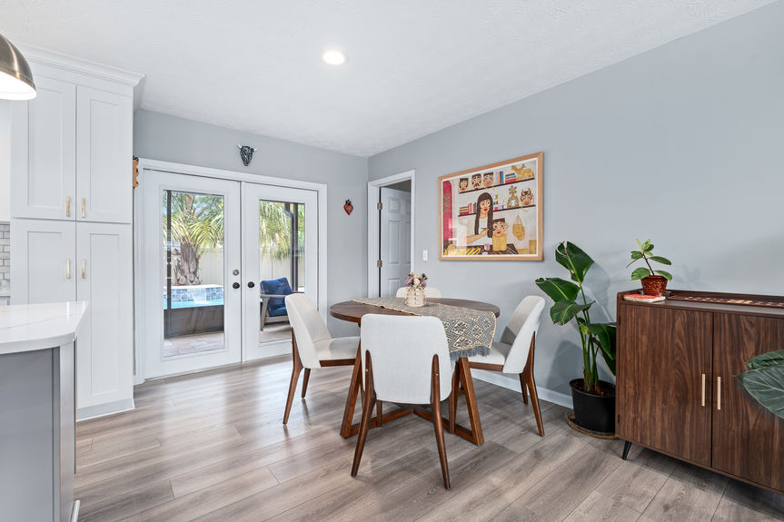 Spacious, light-filled living room featuring recessed lighting, a large sectional sofa, and a fluid layout connecting the main living areas to the kitchen.