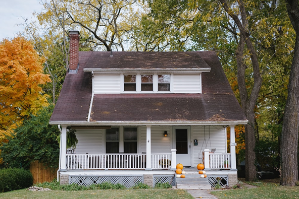 An old home surrounded by trees.