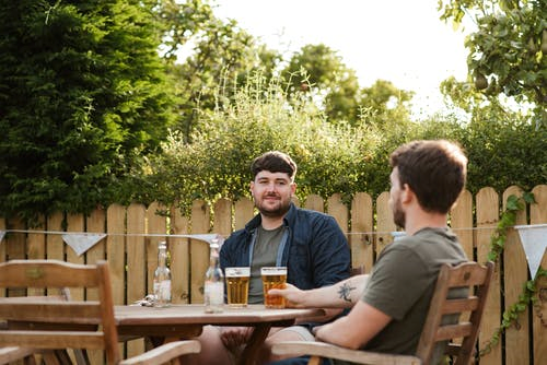 Friends enjoying a beer in the backyard