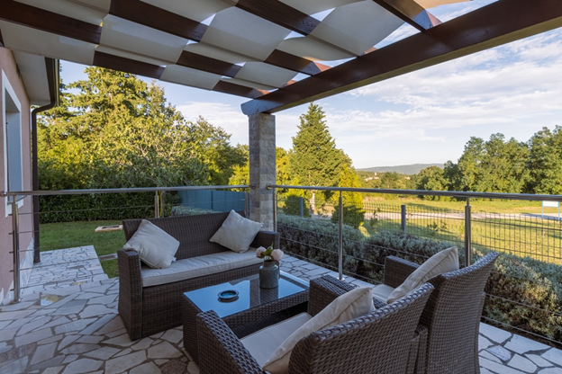 Brown wicker chairs and tables on a patio