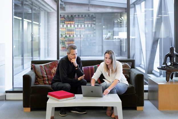 A couple exploring a home listing on the laptop