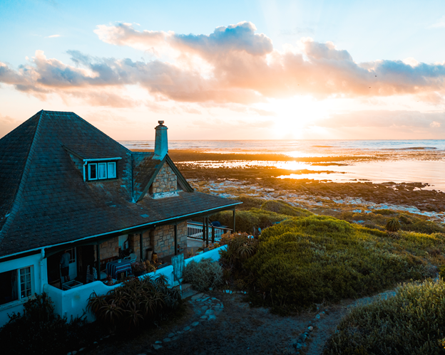 aerial photo of a house near the calm body of water