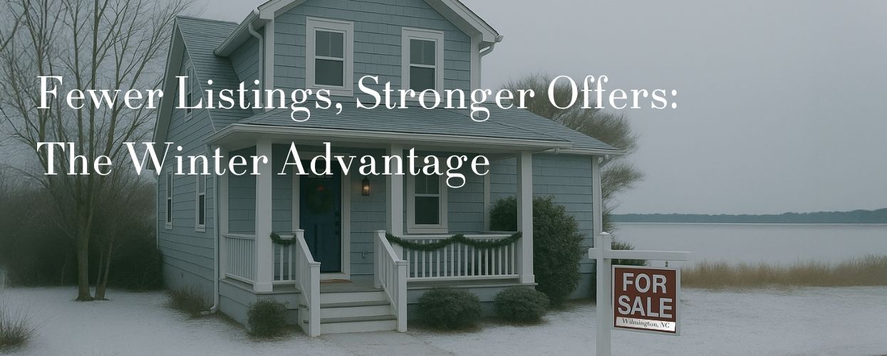 Snow-covered home with For Sale sign near a lake, highlighting winter’s unique real estate appeal.