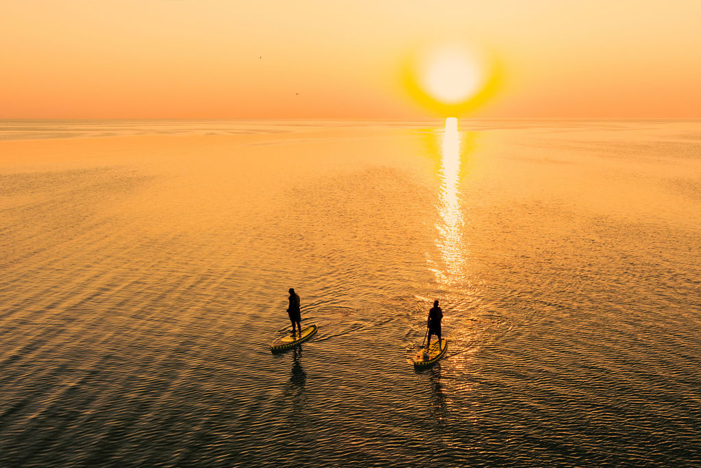 Atlantic Salt Realty paddleboard sunset couple
