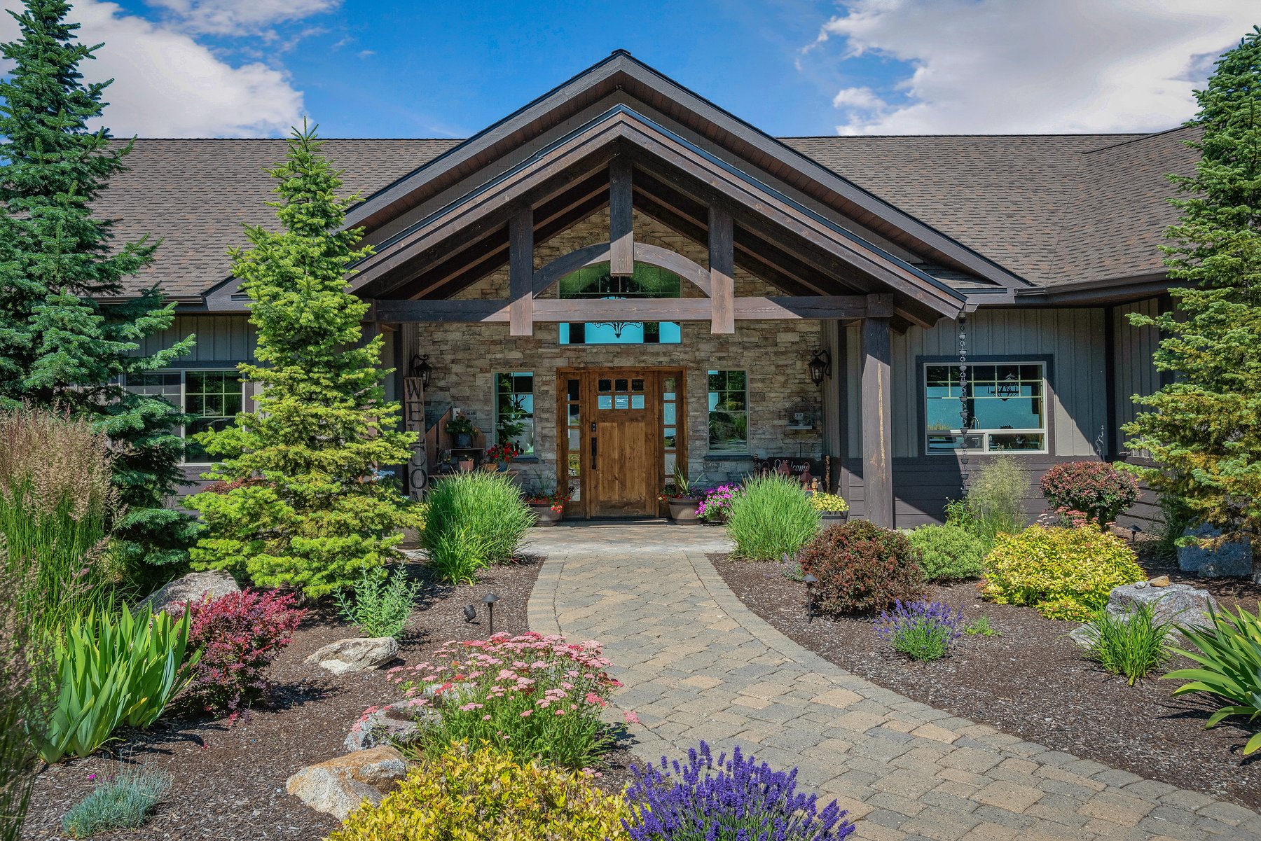 The exterior of a house in Bonners Ferry Idaho. Beautiful landscaping with shrubs blooming