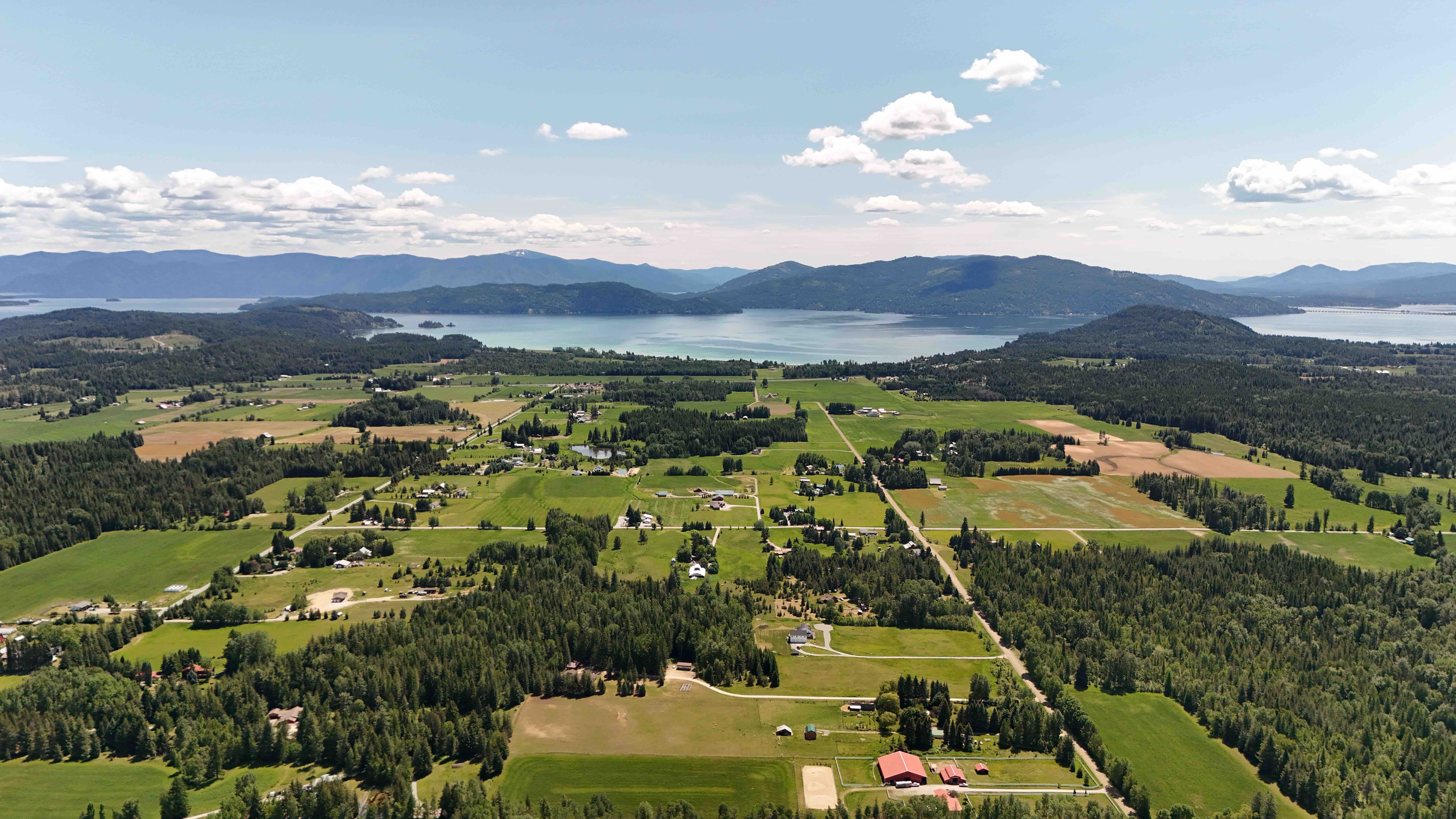 Selle Valley photo taken with a drone, Lake Pend Oreille can be seen and its summer time as there are green fields and pine trees