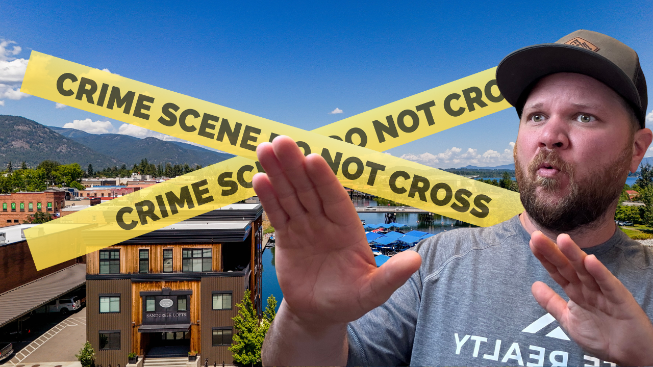 Ben Geanetta, a Sandpoint realtor, with the city of Sandpoint behind him. there is crime scene tape behind him
