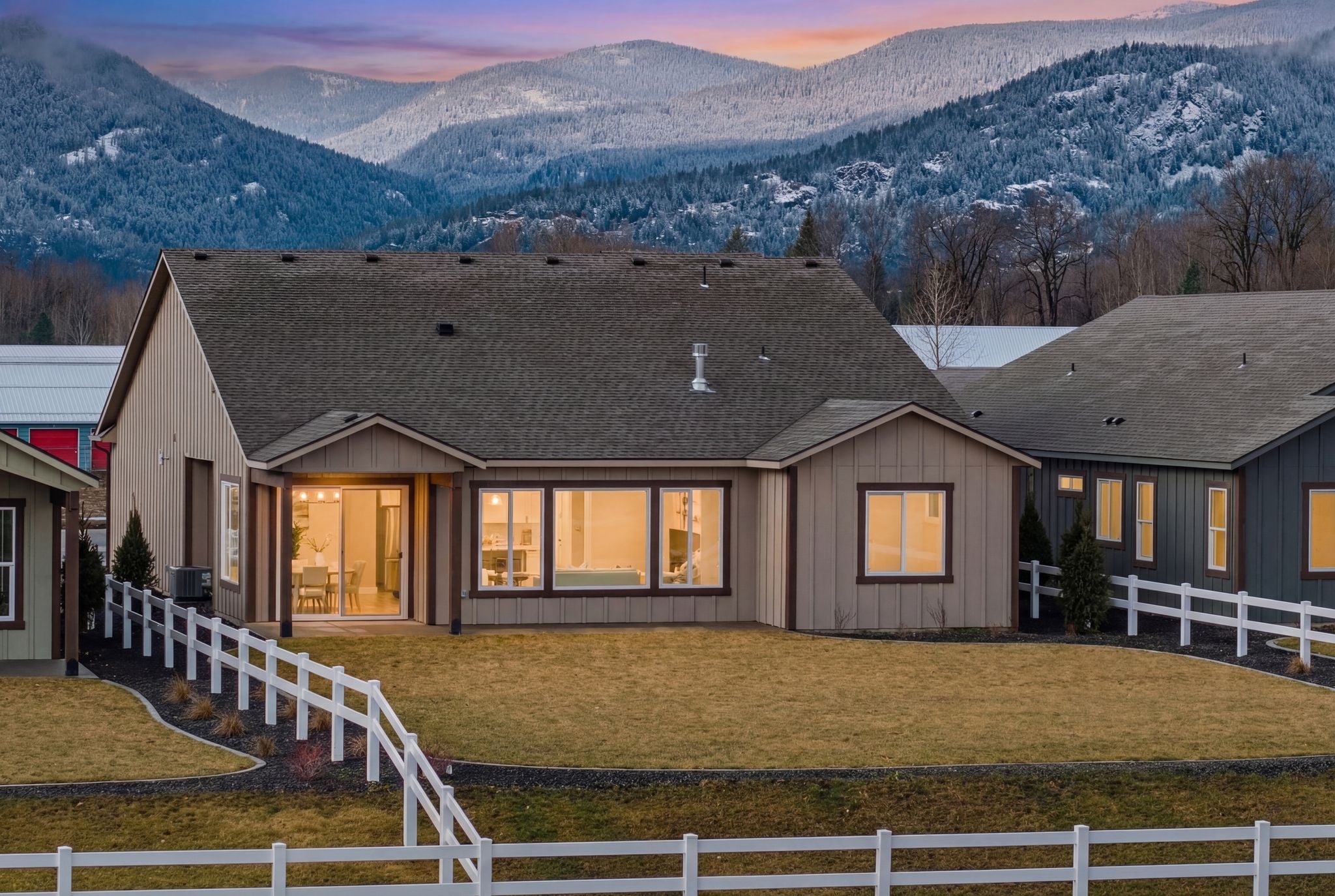 Twilight photo with schweitzer mountain in the background and the backyard of a house