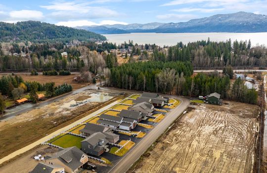 drone photo of homes at The Lodges At Providence with Lake Pend Oreille in the distance