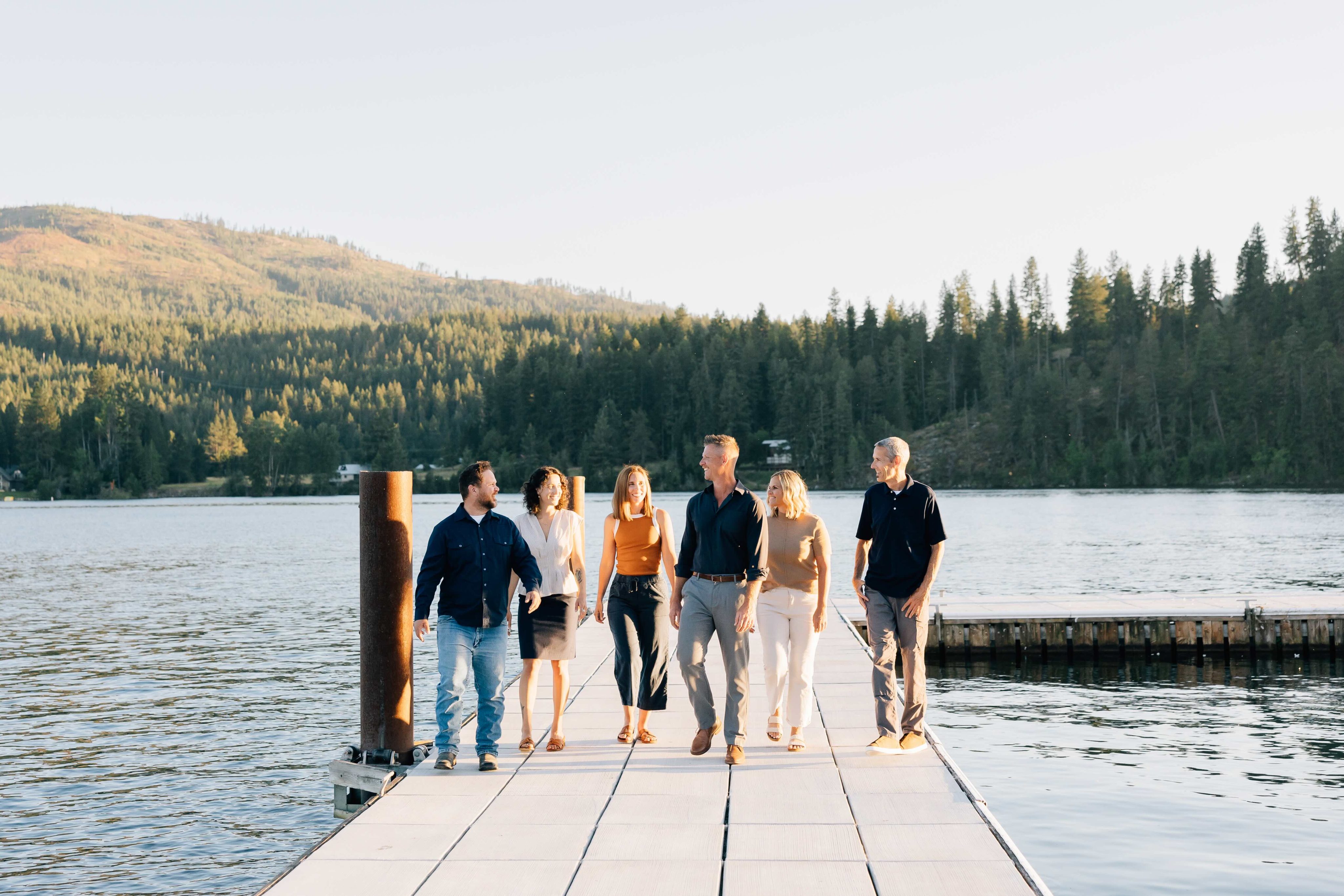 group photo of sandpoint idaho top realtors, Elite Realty Partners, outside at dusk with marina in background