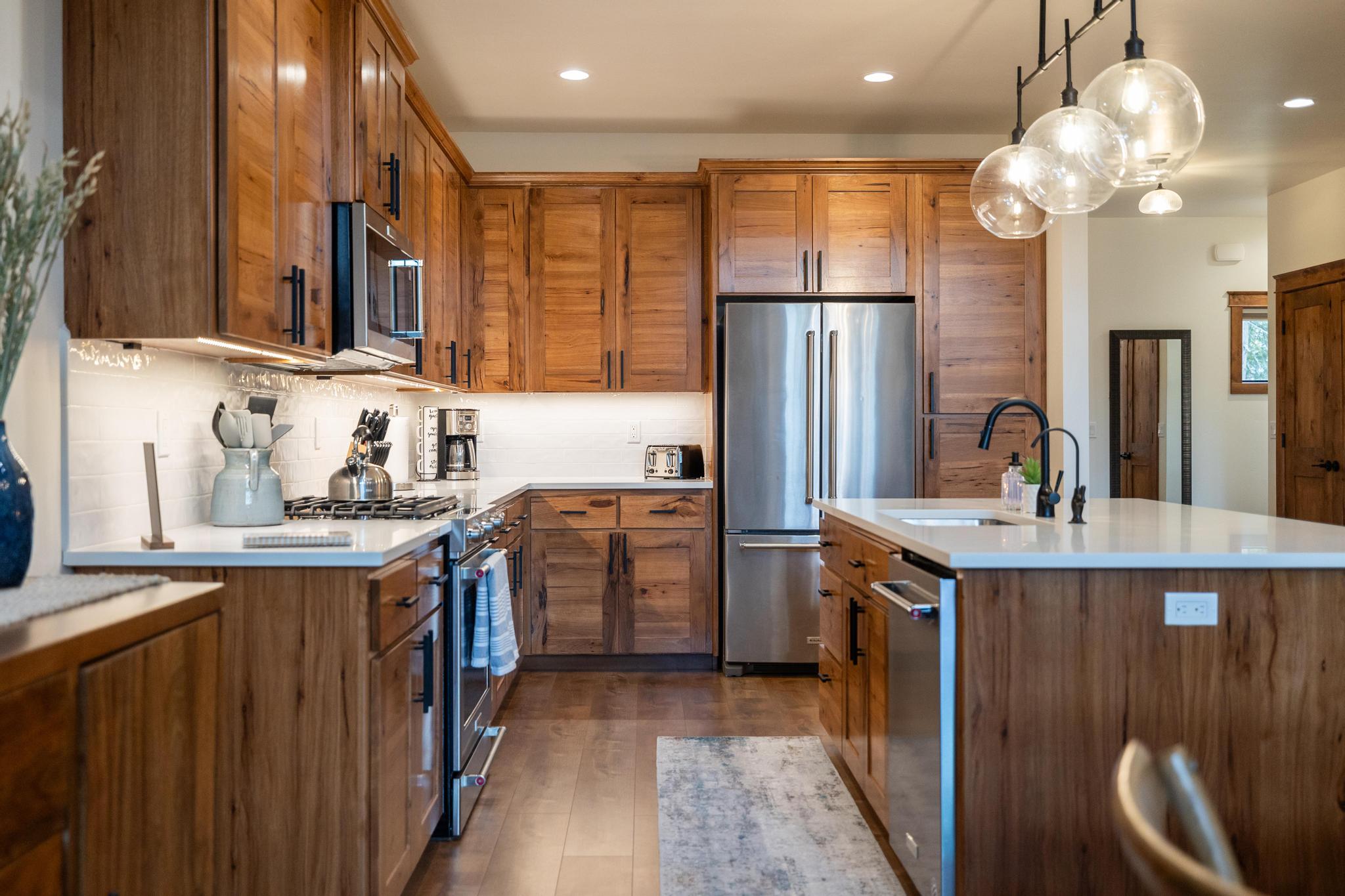 interior kitchen, island with dark wood cabinets and stainless steel appliances