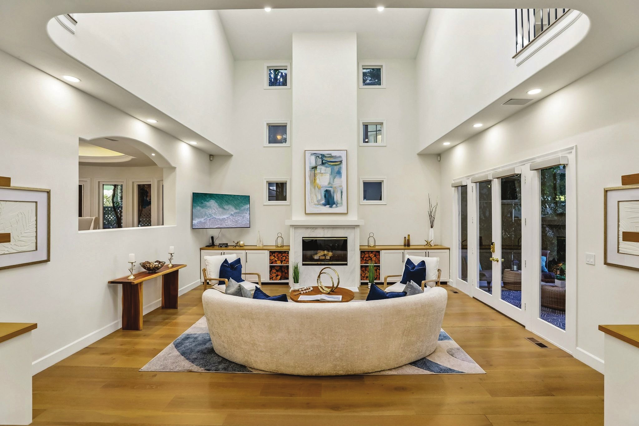 Living room with a double-height ceiling and fireplace at 2300 John Street in Manhattan Beach