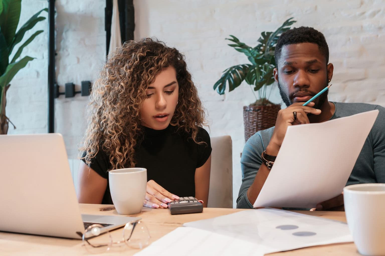 Couple planning their FSBO home sale together at the kitchen table