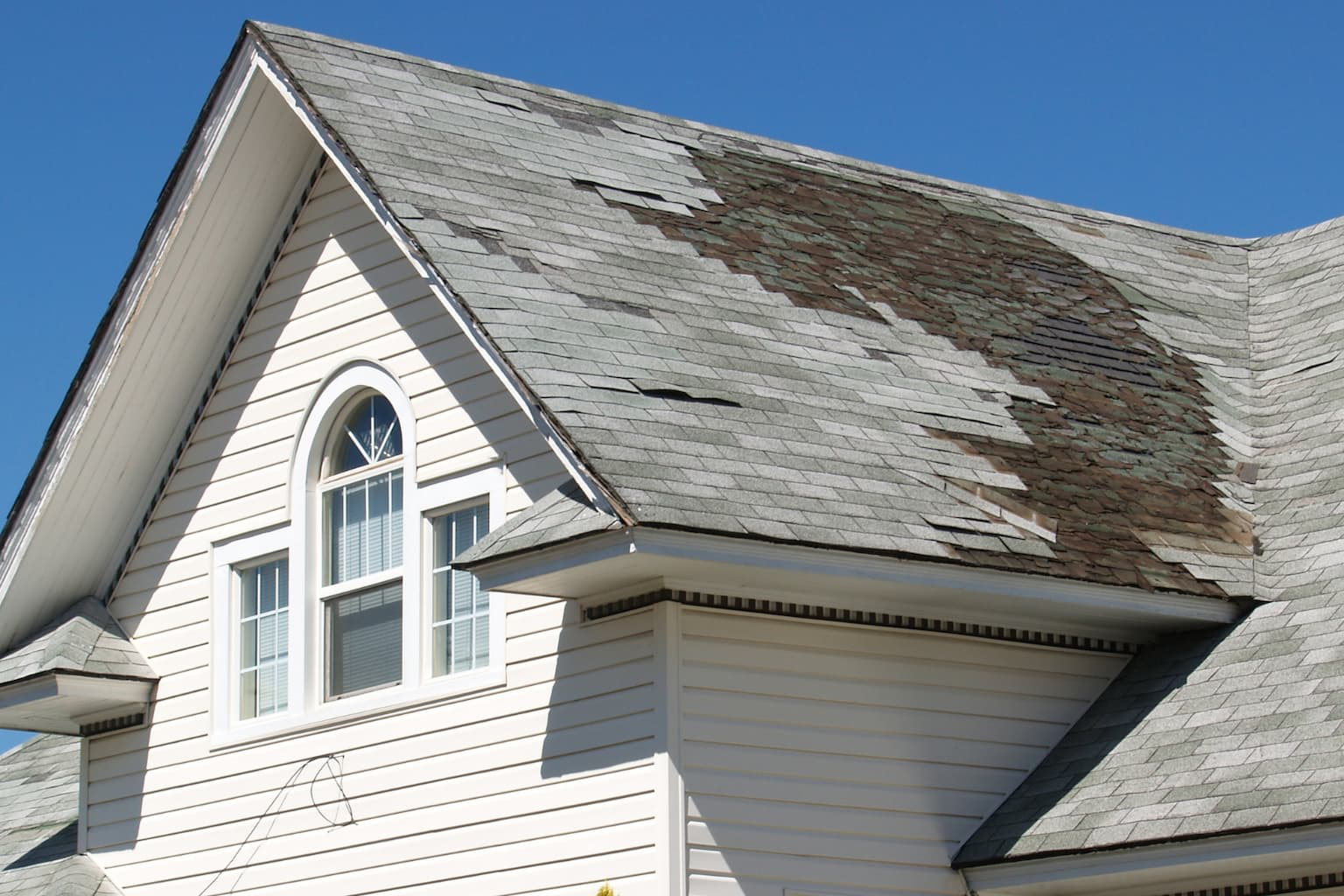 Old house with visible roof and structural damage