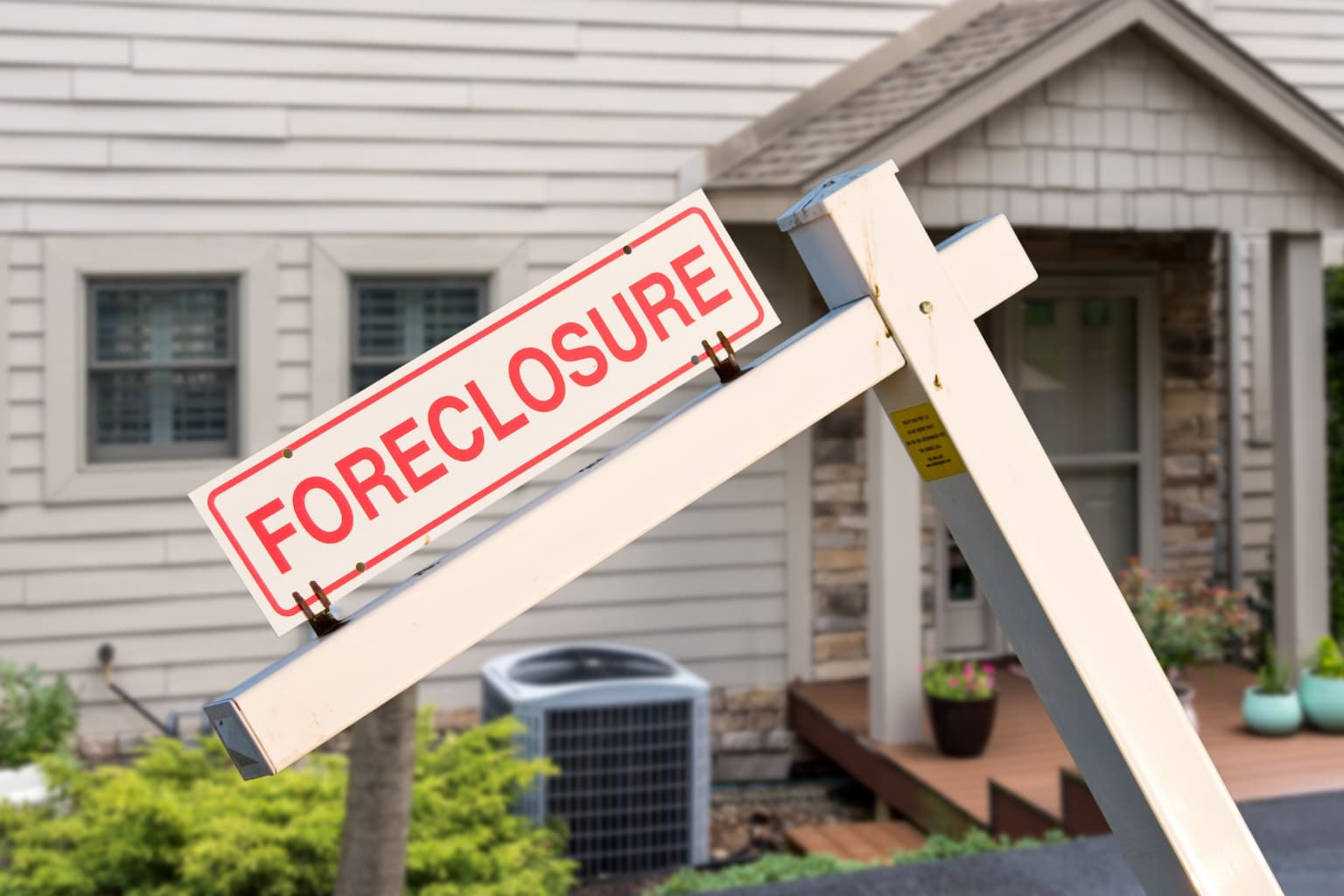 Foreclosure sign posted in front of a house