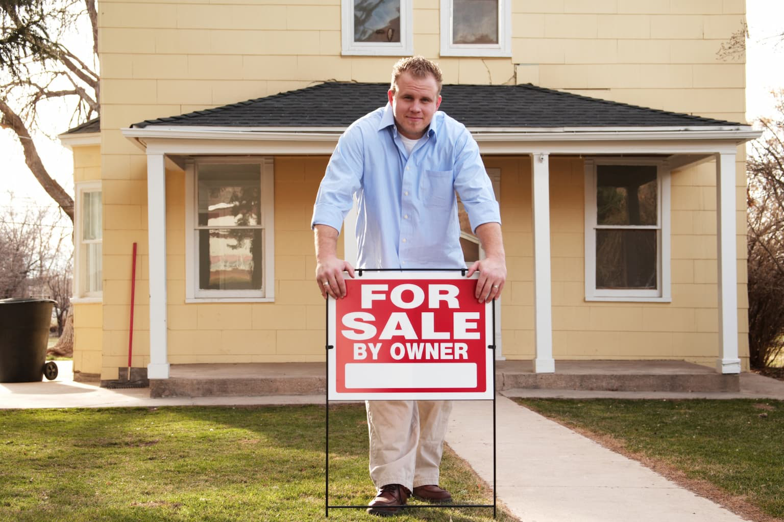For Sale By Owner sign in front of a house
