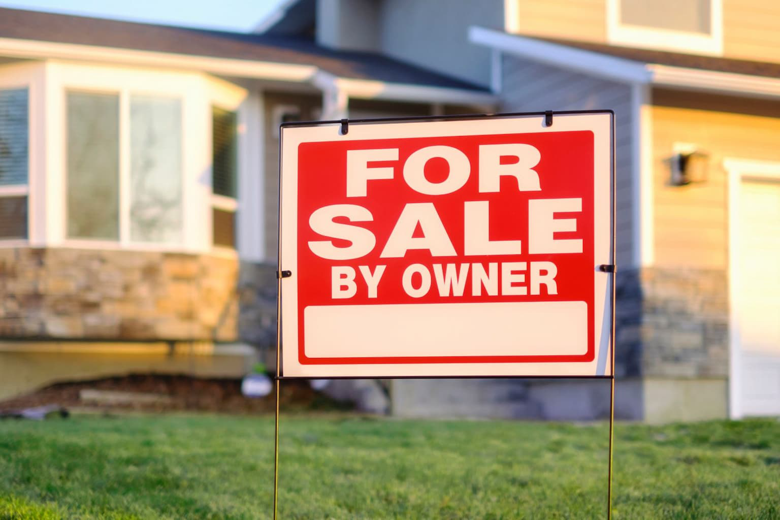 For Sale By Owner sign in front of a home in California