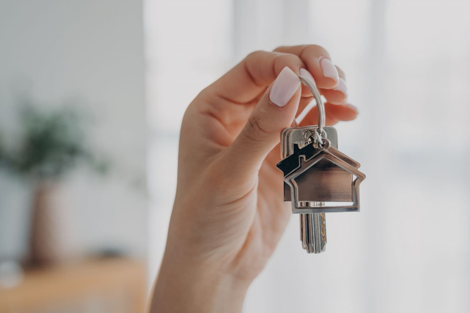 Person handing house keys