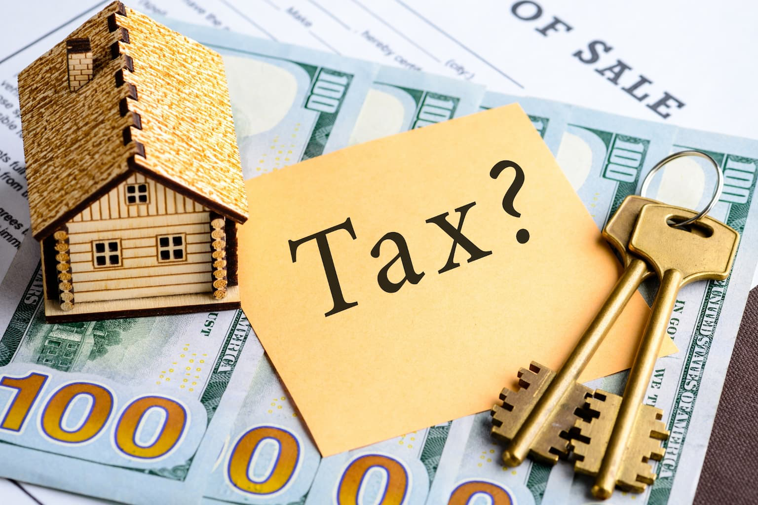 House model with keys, tax note, cash, and home sale document