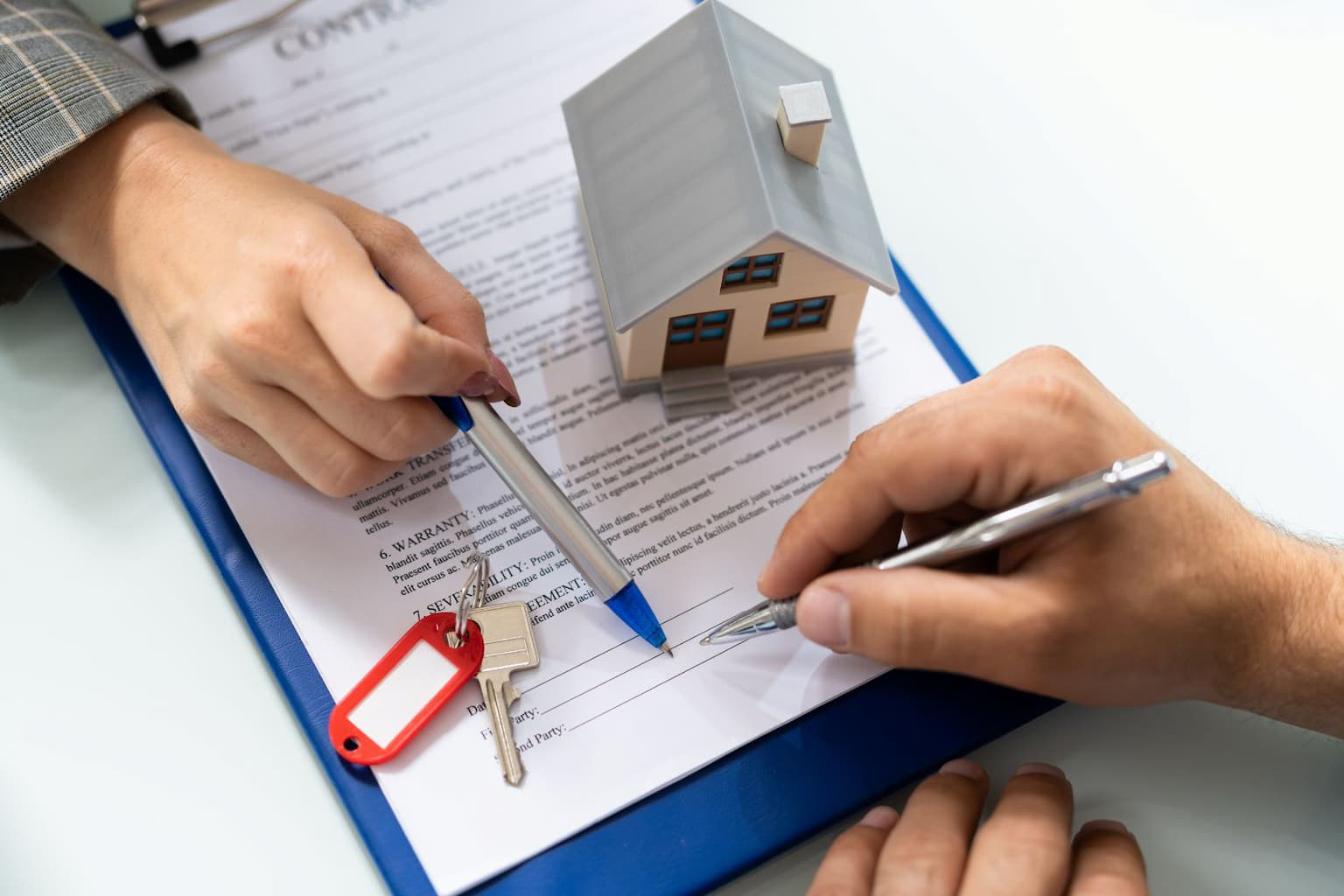 House documents and pen on a table ready for signing